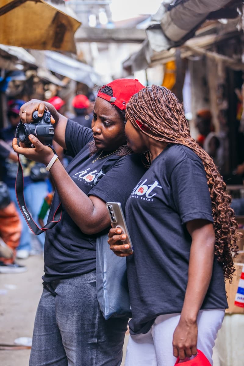 HerLens Cohort 1 participants documenting a local market with a Canon camera
